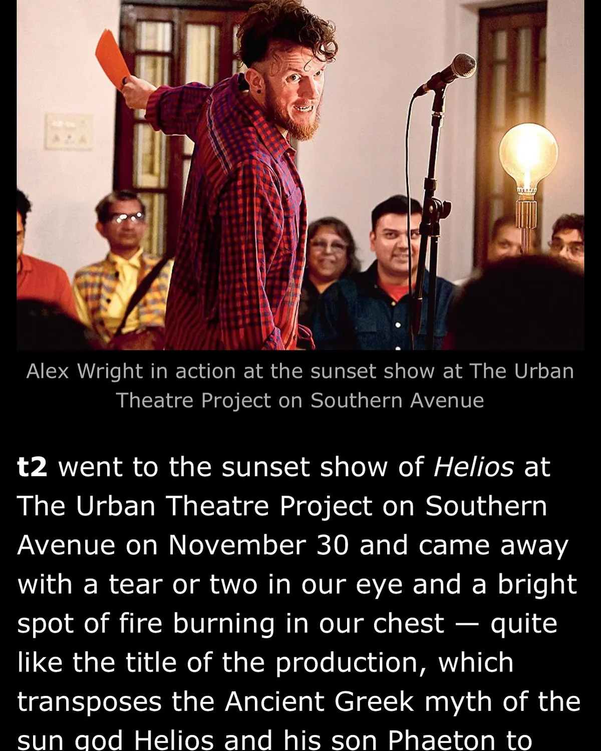 Alexander Wright performing Helios, an audience seated close around him, as printed in t2.